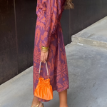 Elegante midi-jurk met twist-detail en bloemmotief – Tijdloos en stijlvol