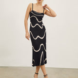 Maisie | Figuuraccentuerende midijurk met abstract patroon en delicate spaghettibandjes